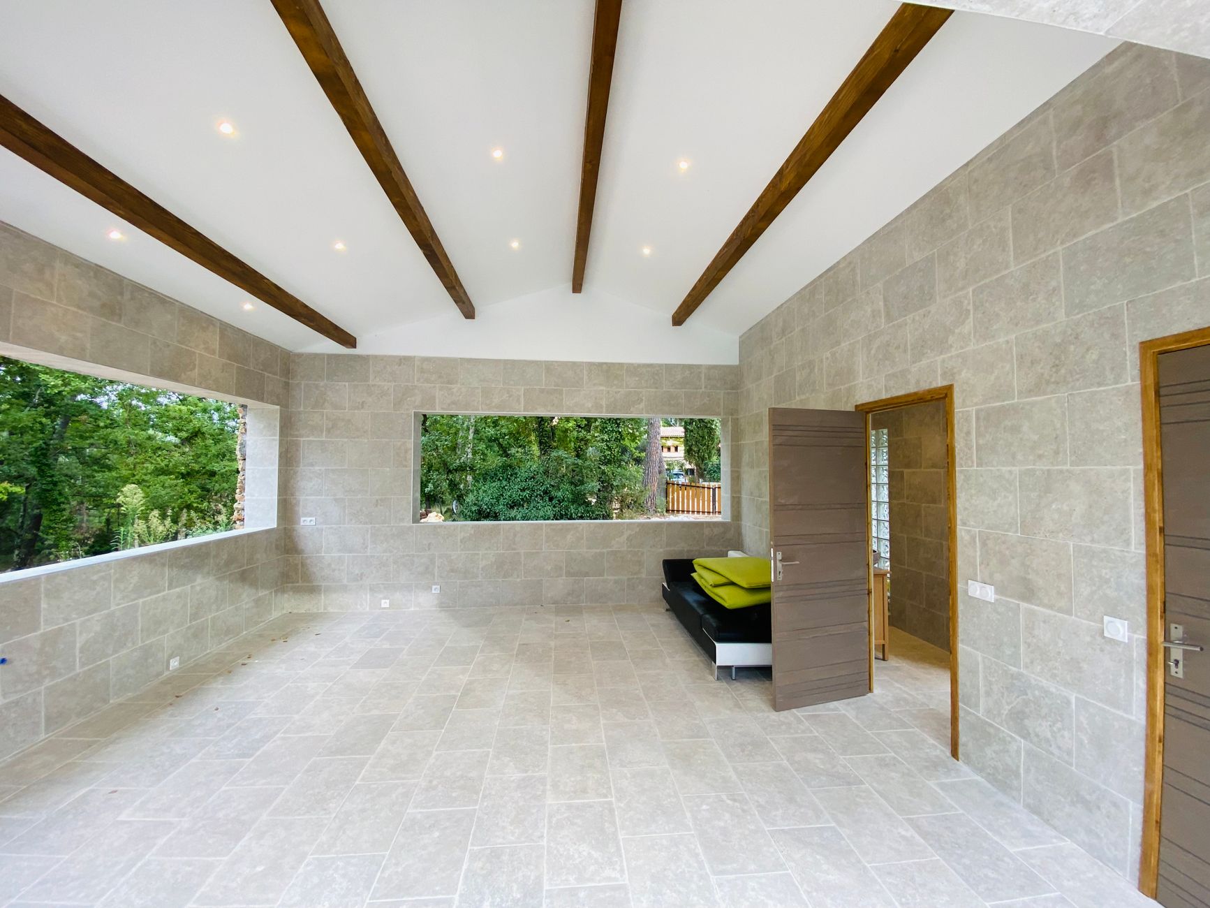 Luxury villa renovation in Dubai — open-plan living area with natural stone flooring and contemporary fit-out