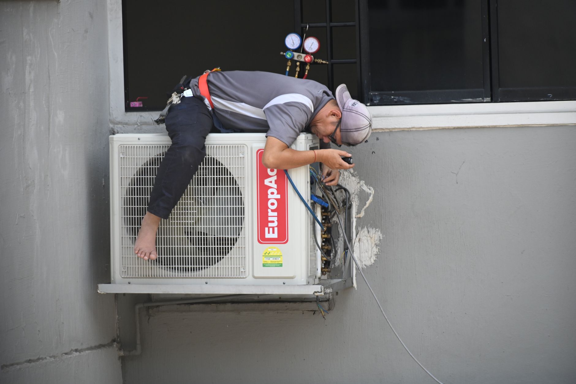 HVAC engineer inspecting indoor unit in a Dubai property